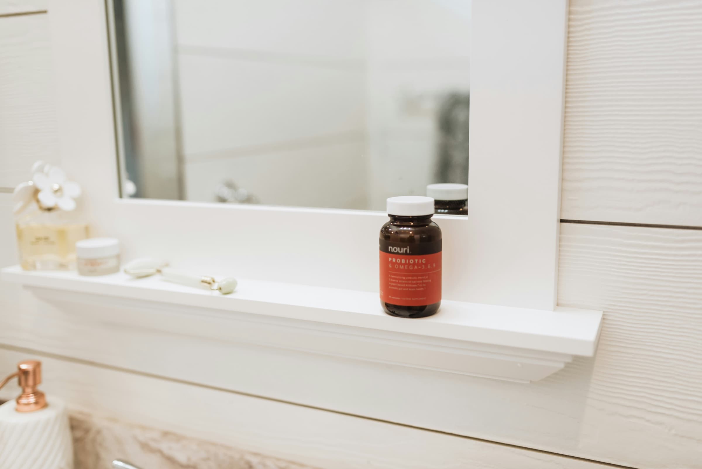 Nouri probiotic and omega supplement bottle in a real consumer setting