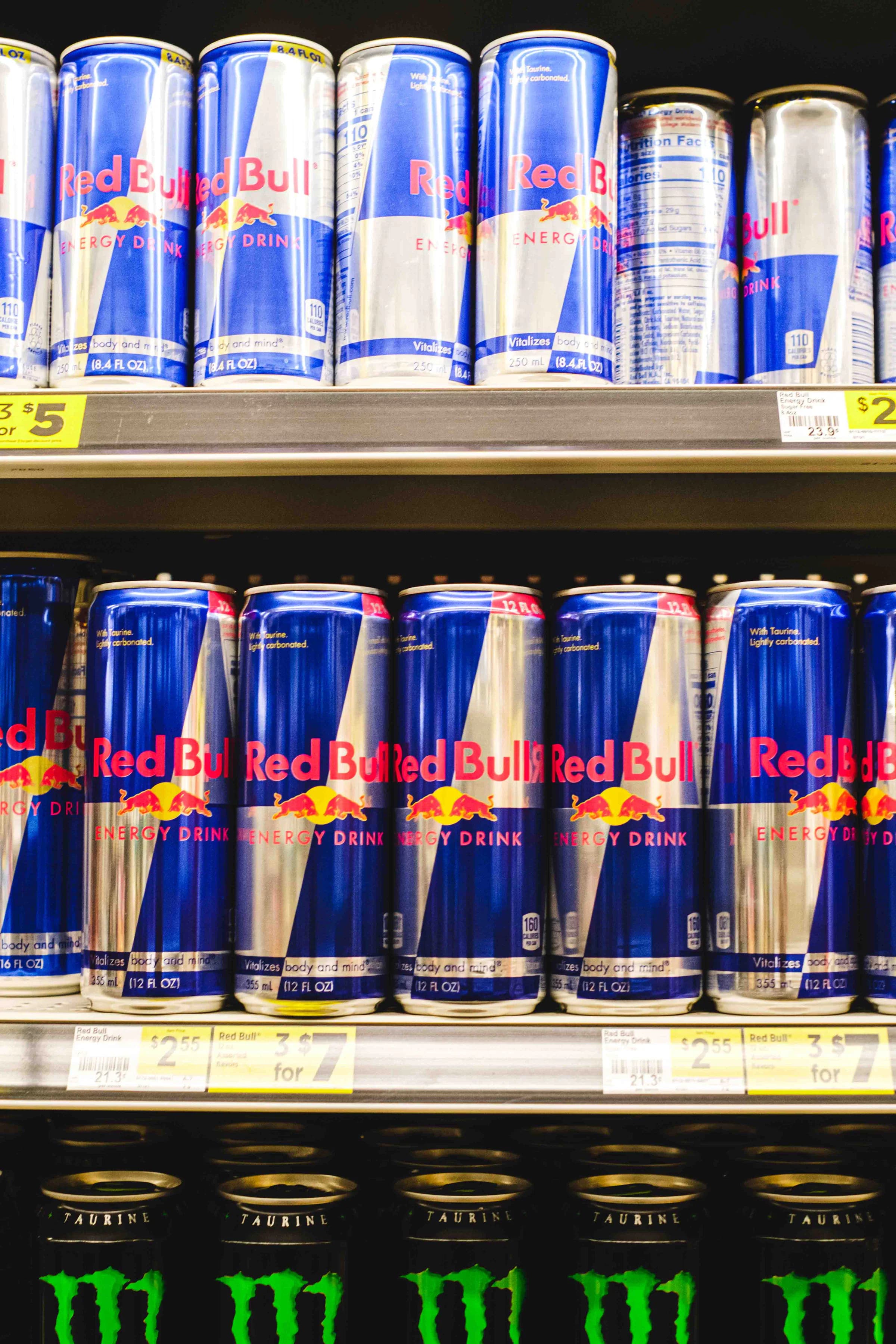 Red Bull energy drink cans displayed on a real retail shelf