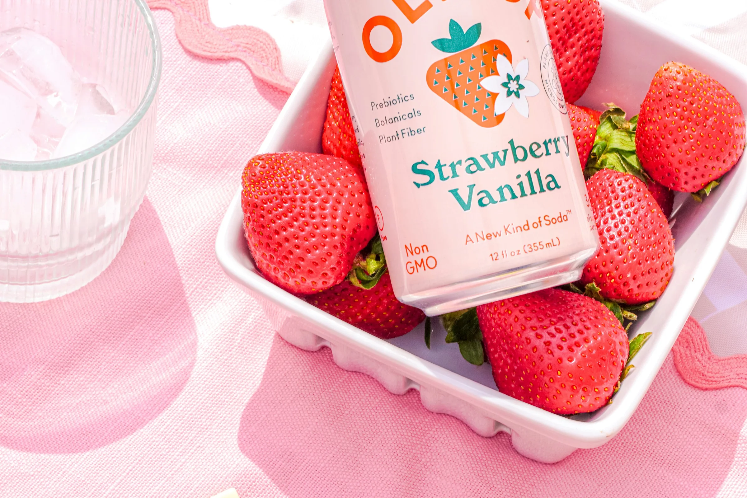 OLIPOP Strawberry Vanilla functional soda styled with fresh strawberries